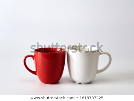 Imagine de stoc: Couple With Coffee Mugs Against White Background With Hearts