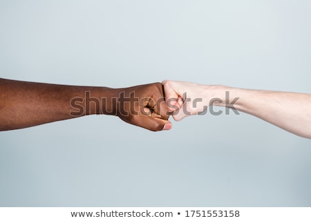 ストックフォト: Men Giving Fist Bump Against Gray Background