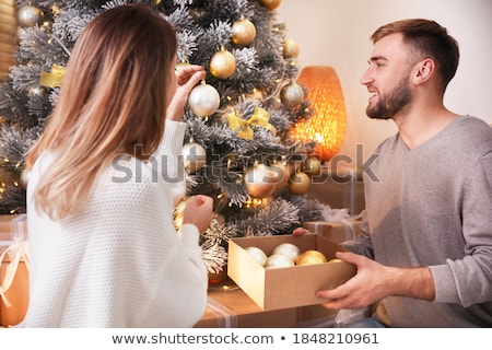 Stock photo: Happy Couple Decorating Christmas Tree At Home