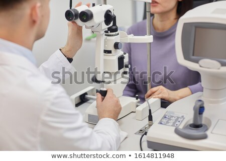 Stockfoto: Crop Man Using Equipment For Eye Testing