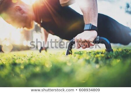 Stock photo: Push Ups - Fitness Man Exercising Outside Doing Pushups Male Fitness Instructor Doing Push Ups On S