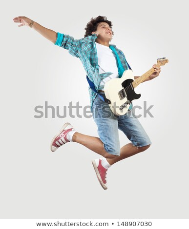 Foto stock: Young Male Jumping With Guitar