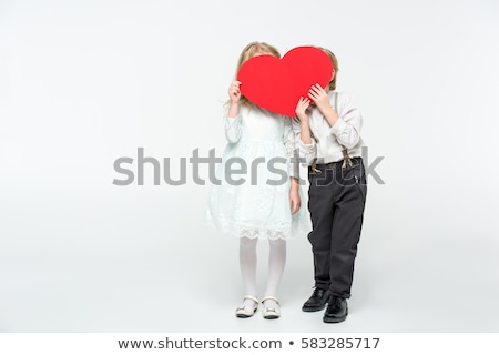 Stockfoto: Couple Hiding Their Face Behind Red Heart