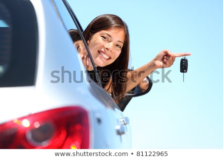 Foto d'archivio: A Beautiful Woman Sitting In Her New Car Holding The Keys