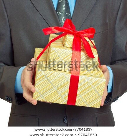 Foto stock: Man Holding Red Christmas Gift In Front Of Body