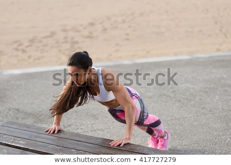 Stok fotoğraf: Fitness Motivated Woman Doing Urban Push Ups Workout