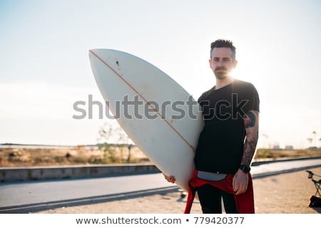 商業照片: Bearded Male Surfer Portrait Holding His Surfboad