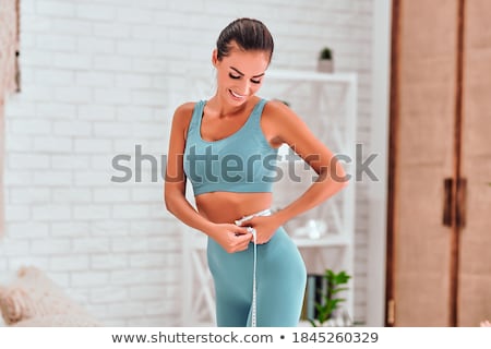 Stock fotó: Woman Measuring Her Waist With A Tape Measure