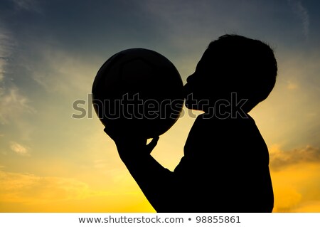 Football Player In Blue Kissing The Ball Stok fotoğraf © manzrussali