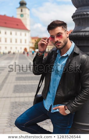 Stockfoto: Handsome Casual Man Leaning Against A Pole In The City