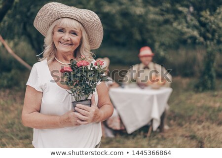 Foto stock: Handsome Man Chatting To Woman In Hammock