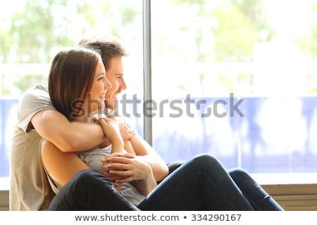 Stockfoto: Romantic Young Couple Embracing In Living Room