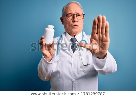 Stock photo: Portrait Of A Male Doctor Holding Pills