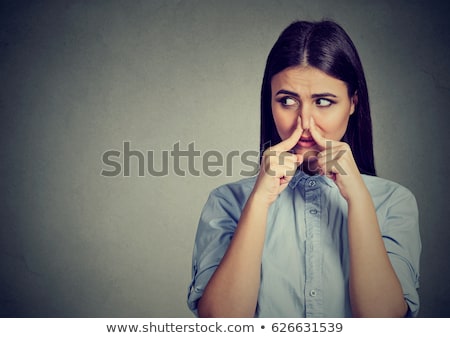 Foto stock: Woman Pinches Nose With Fingers Looks With Disgust Something Stinks Bad Smell
