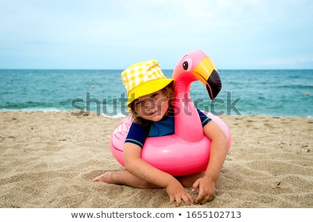 Stock photo: Girl In Swimsuit Sits On Rubber Ring