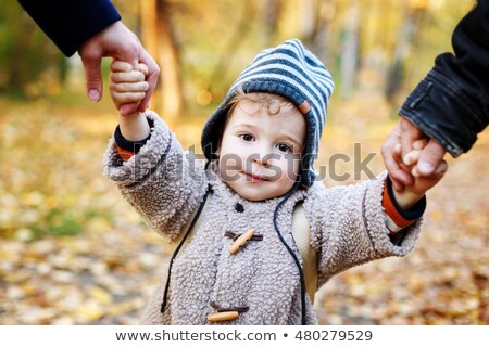 Foto stock: Cute Smilimg Kid In Warm Clothes Having Fun