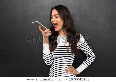 Stock fotó: Angry Brunette Woman In Sweater With Arm On Hip