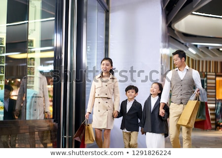 [[stock_photo]]: Shopping Family With Children Carrying Paper Bags