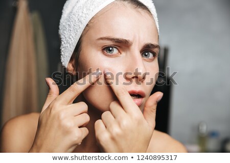 Zdjęcia stock: Photo Of Upset Woman With Towel On Head Squeezing Pimple On Her