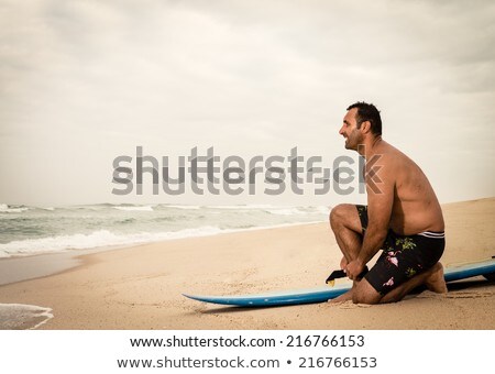 Surfer Tying His Surfboards Leach [[stock_photo]] © homydesign