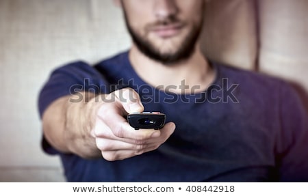 Сток-фото: Man Holding Remote Control On Couch