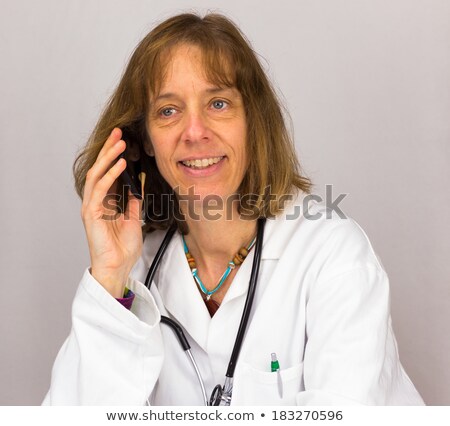 Stok fotoğraf: Dutch Female Doctor Calling With Mobile Phone