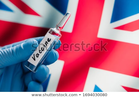 Foto stock: New Coronavirus Vaccine Against Uk Flag As Background Fight Against Covid 19 British Medical Resea