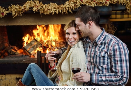 Woman Sitting On A Sofa In Front Of A Fireplace [[stock_photo]] © dotshock