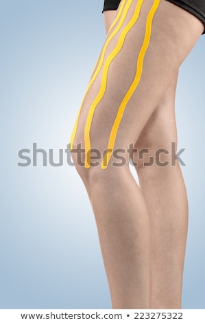 Foto stock: Therapeutic Treatment Of Leg With Blue Physio Tape