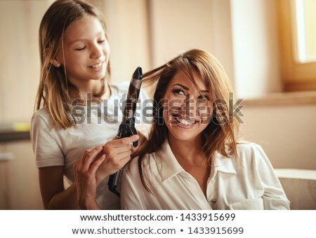 Young Girl Curling Her Hair Stockfoto © MilanMarkovic78