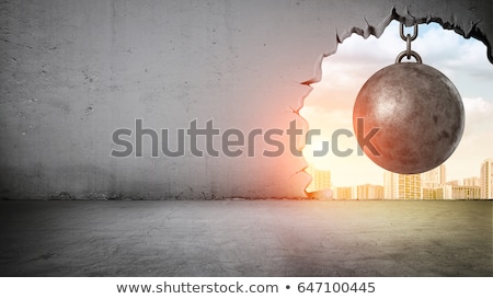 [[stock_photo]]: Damaged Concrete Wall With Bricks Showing