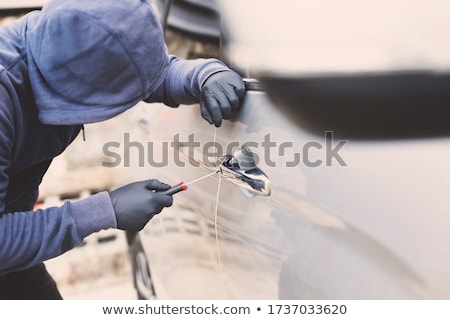 Stock photo: Car Theft - Thief Trying To Break Into The Vehicle