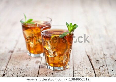 Stock photo: Traditional Iced Tea With Lemon Mint Leaves And Ice Cubes In Gl