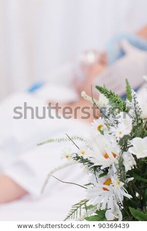 Zdjęcia stock: Two People On Bed Next To Two Surgical Masks