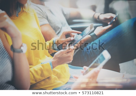 Foto d'archivio: Young Businessman Using Mobile Phone And Working On Laptop