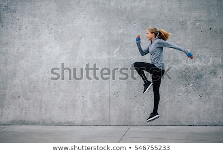 Foto d'archivio: Young Female Against Grey Wall