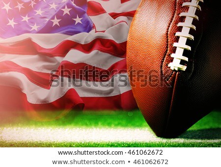 ストックフォト: Football Ball On Grass With American Flag