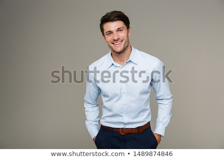 Foto d'archivio: Closeup Of A Young Smiling Business Man Standing Confidently Aga