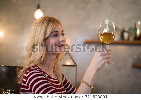 Foto stock: Thoughtful Woman Having Glass Of Wine At Counter