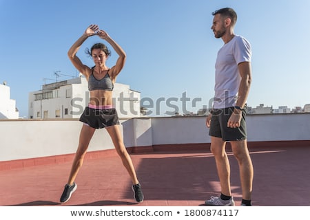 Сток-фото: Woman Exercising With Trainer On Rooftop