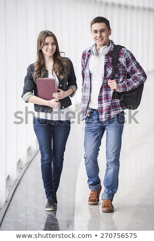 Stockfoto: Full Length Of Two Smiling Young Students Girls Walking