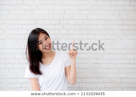 Stock photo: Trendy Young Woman Pointing At Something