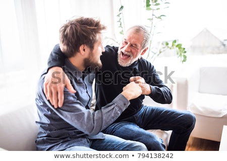 Сток-фото: Senior Father And Son Sitting On Sofa