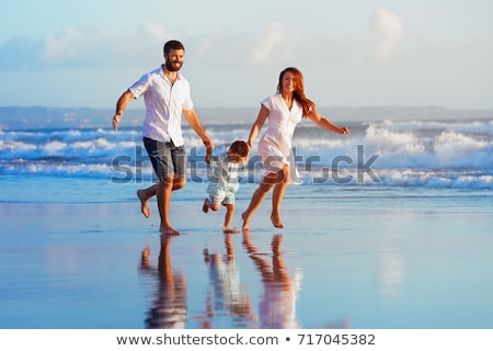 Foto d'archivio: Feet Of Father And Son At The Wet Sand Of The Beach