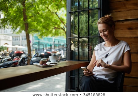 Сток-фото: Girl Smiling And Relaxing While Text Messaging