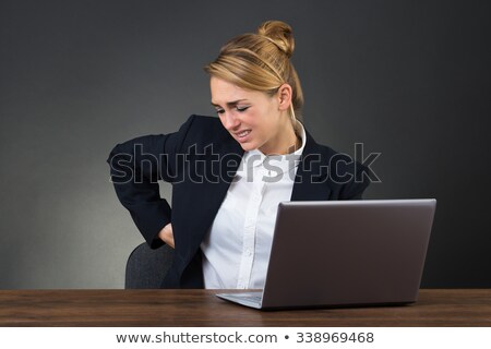 Foto d'archivio: Businesswoman Suffering From Backpain While Using Laptop