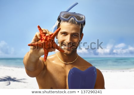 Zdjęcia stock: Happy Young Scuba Diver Holding Sea Star Smiling Looking At Camera