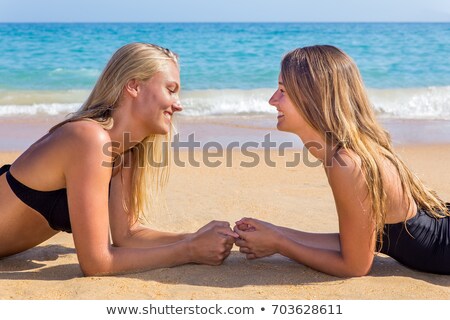 Stock fotó: Two Dutch Girls Lying Opposite On Beach