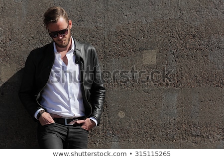 Stock fotó: Confident Man Wearing Leather Jacket And Sunglasses Looks To Sid