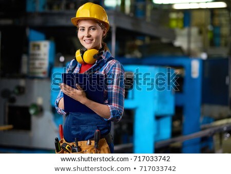 [[stock_photo]]: Attractive Young Female Technician Carrying Out Inspection At Pr